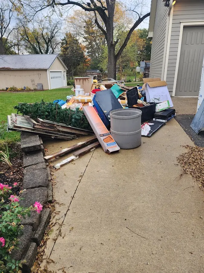 Dumpster being loaded with debris for Commercial Dumpster Rental in Williamston